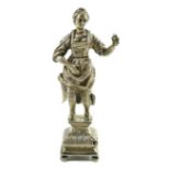 A late 19th century Dutch silver erotic miniature figure of a lady, on a square base with ball feet,