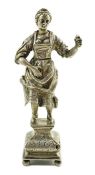 A late 19th century Dutch silver erotic miniature figure of a lady, on a square base with ball feet,