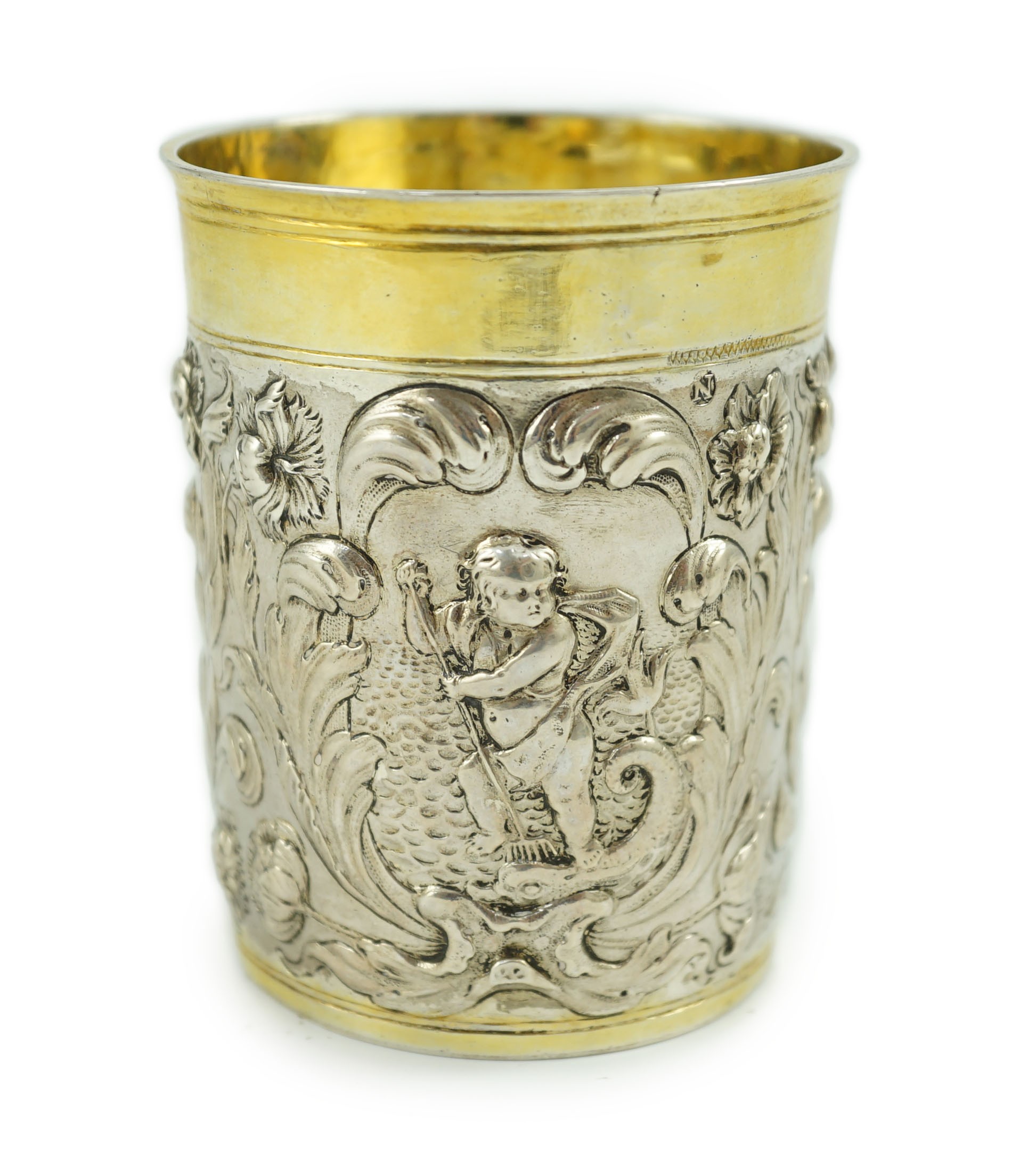 A late 18th century German embossed parcel gilt silver beaker, maker SBF, decorated with putti
