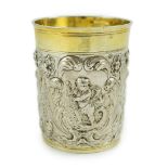 A late 18th century German embossed parcel gilt silver beaker, maker SBF, decorated with putti