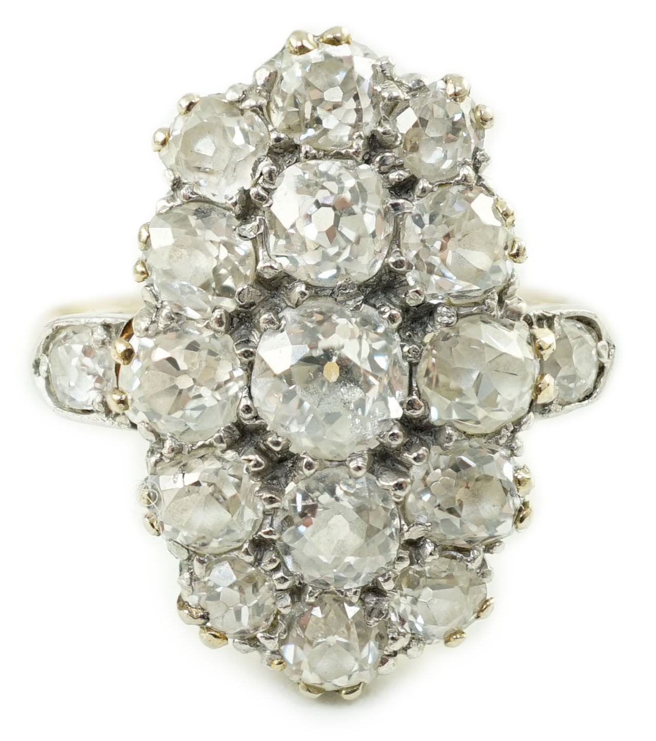 An 18ct gold and oval diamond cluster dress ring, with diamond set shoulders, set with seventeen