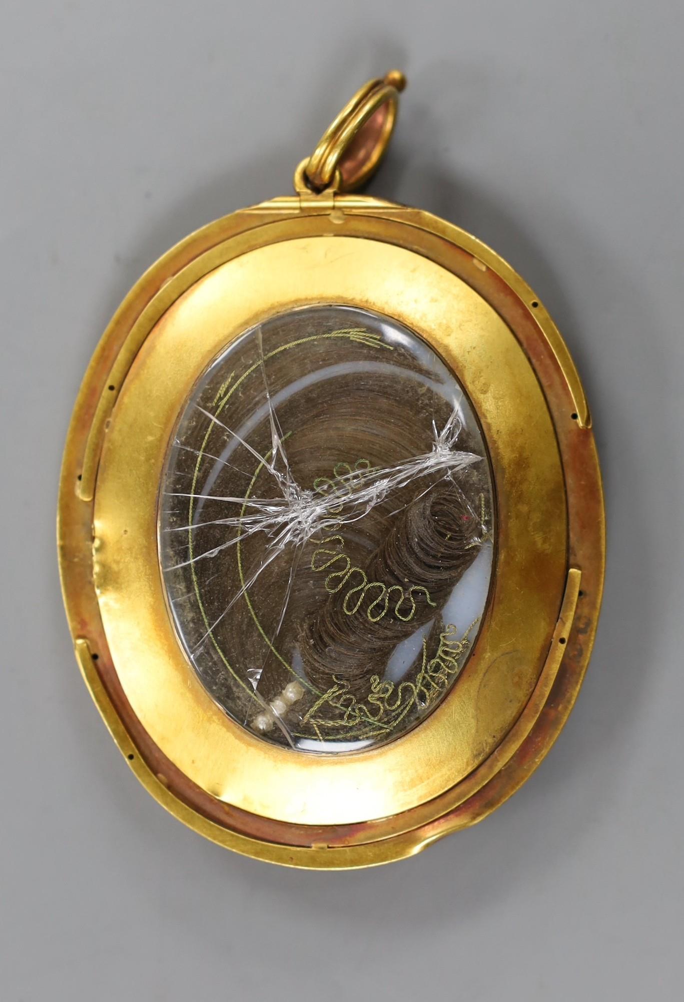 A yellow metal mounted oval portrait miniature of a young lady pendant miniature, the glazed back - Image 2 of 2