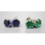 Two pairs of white metal ear studs, one set with green paste, the other with synthetic sapphires,