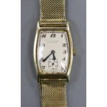 A gentleman's 14k tonneau shaped manual wind wrist watch, retailed by E. Cubelin, with Arabic dial