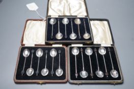 Three assorted cased sets of six silver bean end coffee spoons.