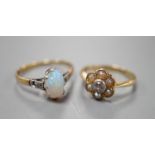 An 18ct and Plat, split pearl and diamond cluster set ring, size F/G and a similar white opal set