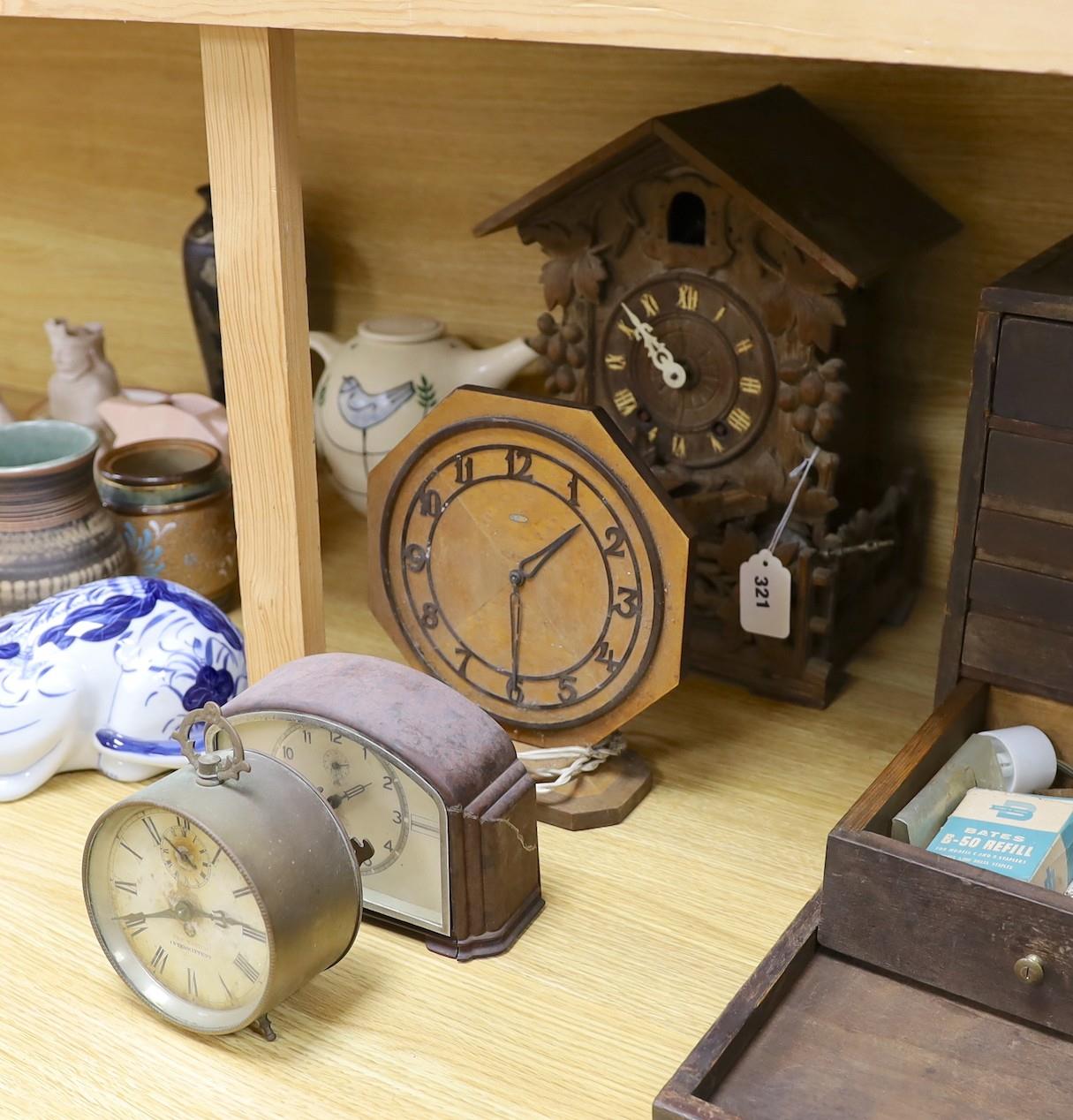 A Black Forest cuckoo clock, together with another octagonal faced timepiece, a Bakelite timepiece