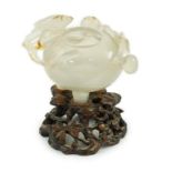 A Chinese small carved agate brushwasher on wooden stand, 19th century