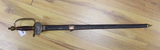 An 18th century European brass hilted sword and scabbard. 89cm long