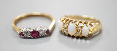 An Edwardian 18ct gold and three stone white opal set ring, with diamond chip spacers, size F and an