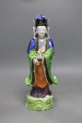 A Chinese enamelled porcelain figure of Guanyin, Jiaqing - Daoguang period, damage, 34cms high,