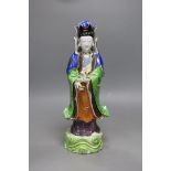 A Chinese enamelled porcelain figure of Guanyin, Jiaqing - Daoguang period, damage, 34cms high,