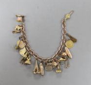 A 9ct charm bracelet, hung with assorted charms including two 9ct, silver and enamel, gilt metal and
