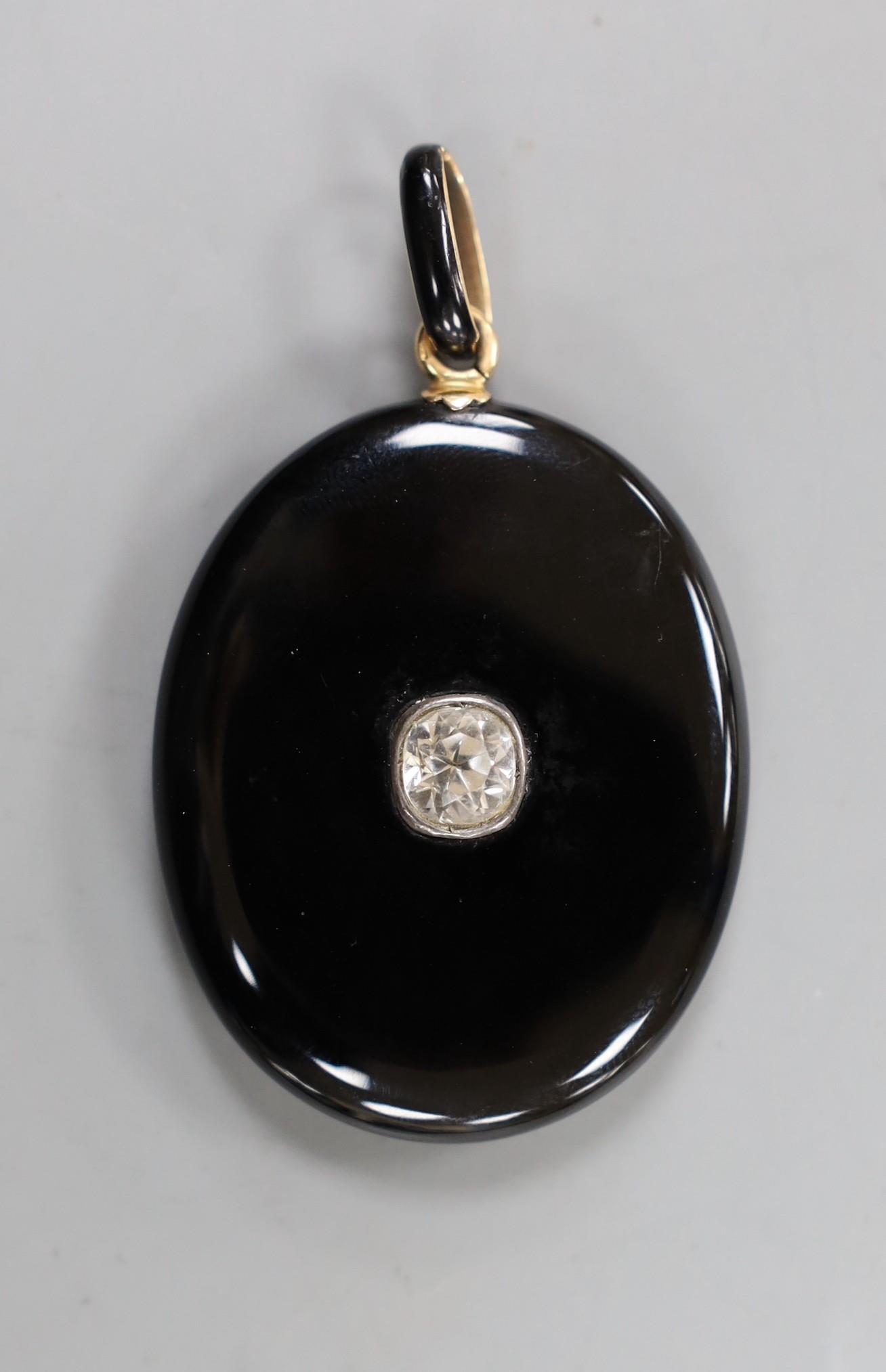 A Victorian black enamelled yellow metal oval locket, set with an old cut white sapphire, overall - Image 2 of 2