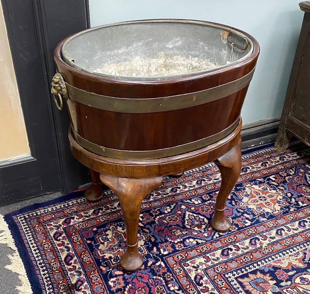 A George III style oval brass bound mahogany wine cooler on stand, width 60cm, depth 44cm, height