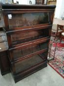 A Globe Wernicke glazed oak four section bookcase, width 86cm, depth 27cm, height 140cm