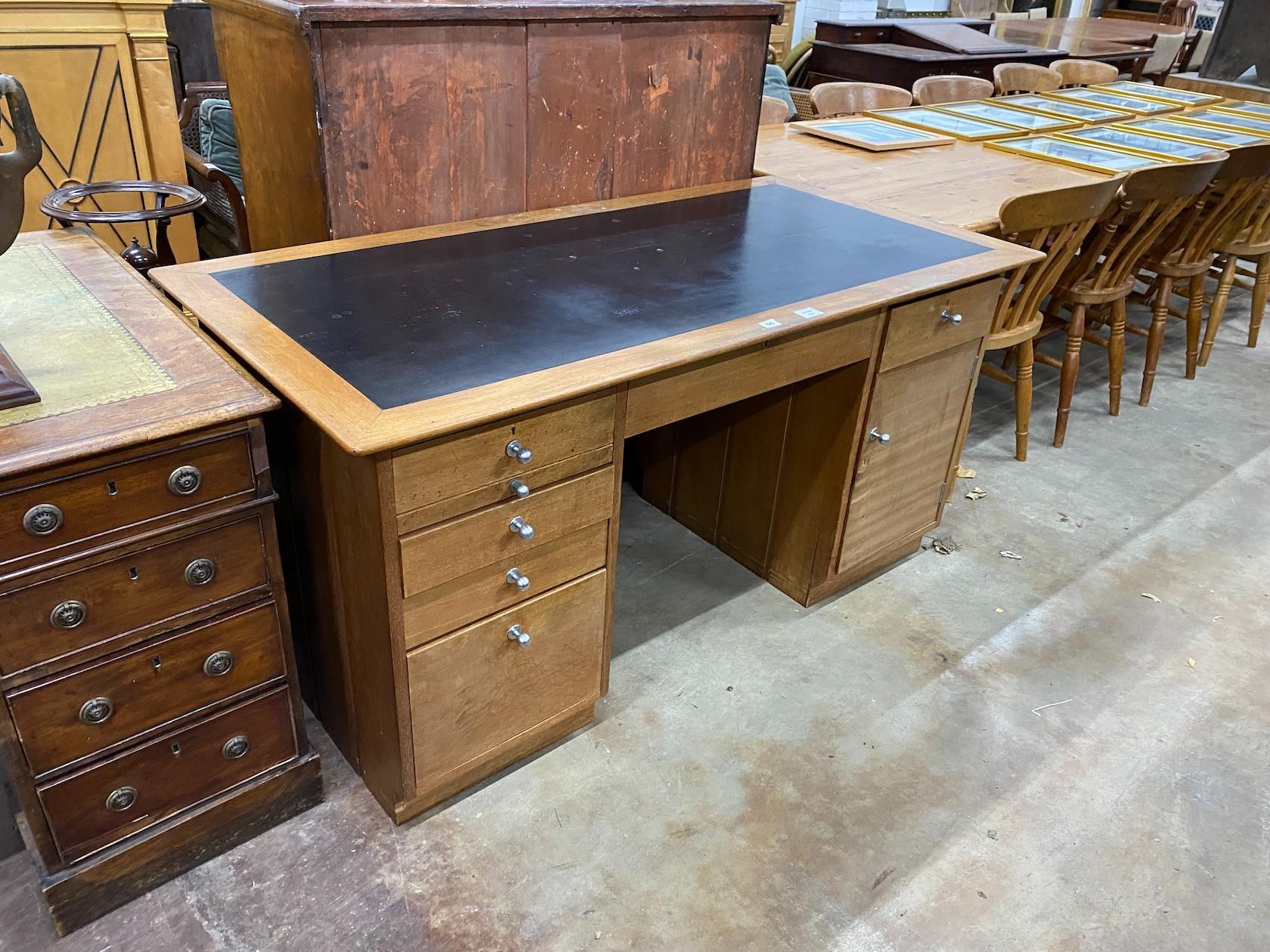 A mid century teak kneehole desk, length 152cm, depth 76cm, height 76cm