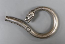 A Japanese? white metal cane handle, with cabochon eyes and terminal modelled as the head of a
