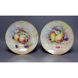 A pair of Minton fruit painted plates, signed A. Holland, 23cm diameter, together with two books