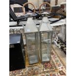 A pair of contemporary square metal and glass lanterns, height 115cm (one pane broken)