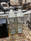 A pair of contemporary square metal and glass lanterns, height 115cm (one pane broken)