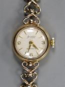 A lady's 9ct gold Accurist manual wind wrist watch, on a 9ct gold bracelet, overall 17.8cm, gross