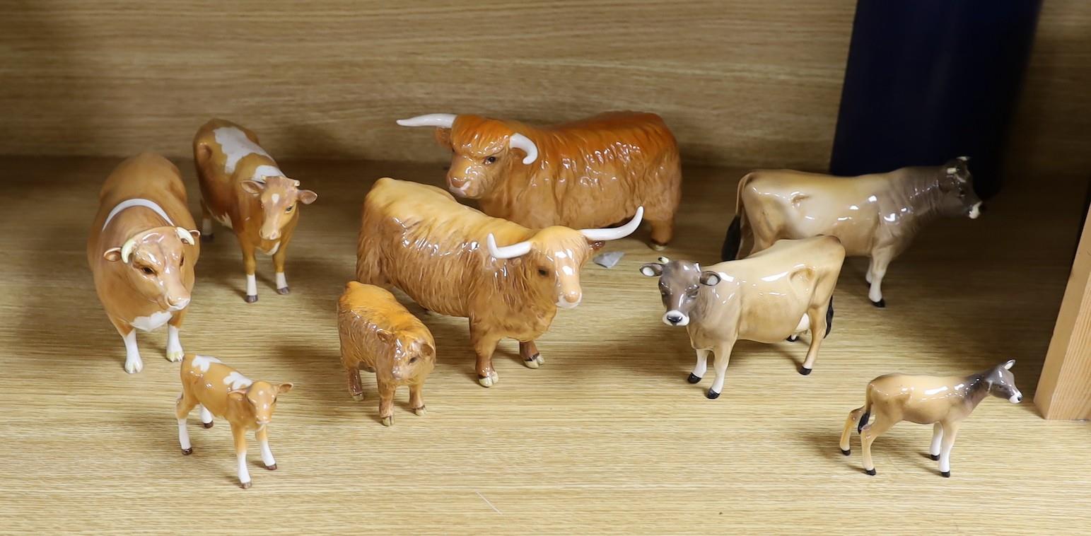 A Beswick Highland bull, cow and calf, a similar Freisian bull, cow and calf and a Dulsby Coy Boy,