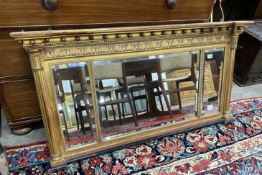 A large Regency giltwood and composition triple plate overmantel mirror, width 130cm, height 66cm