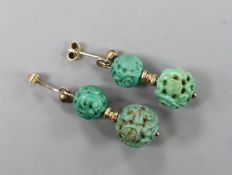 A pair of Chinese yellow metal and two turquoise bead set earrings, both carved with Shou