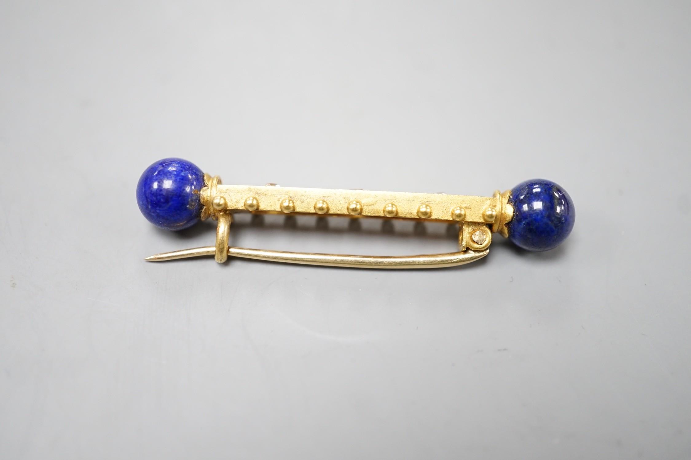 A yellow metal and three stone diamond set bar brooch. with lapis lazuli bead set terminals, 43mm, - Image 2 of 2