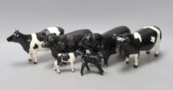A Beswick Aberdeen Angus bull, cow and calf, together with a Godington Hilt Bar bull, cow and calf,