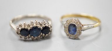 An 18ct white metal, sapphire and diamond set triple cluster ring, size O and a yellow metal,