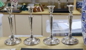 A set of four 19th century silver plated candlesticks. 29cm