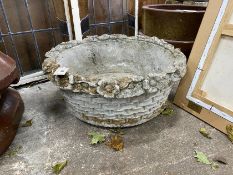 A circular reconstituted stone basket weave garden planter with floral rim, diameter 60cm, height