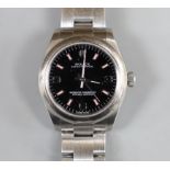 A lady's 2011 stainless steel Rolex Oyster Perpetual wrist watch, on a stainless steel Rolex