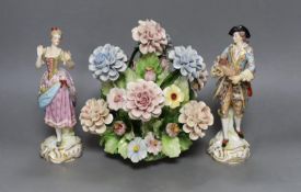 A pair of Continental porcelain figures and a Naples flowers bouquet. 22cm tall