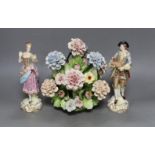 A pair of Continental porcelain figures and a Naples flowers bouquet. 22cm tall