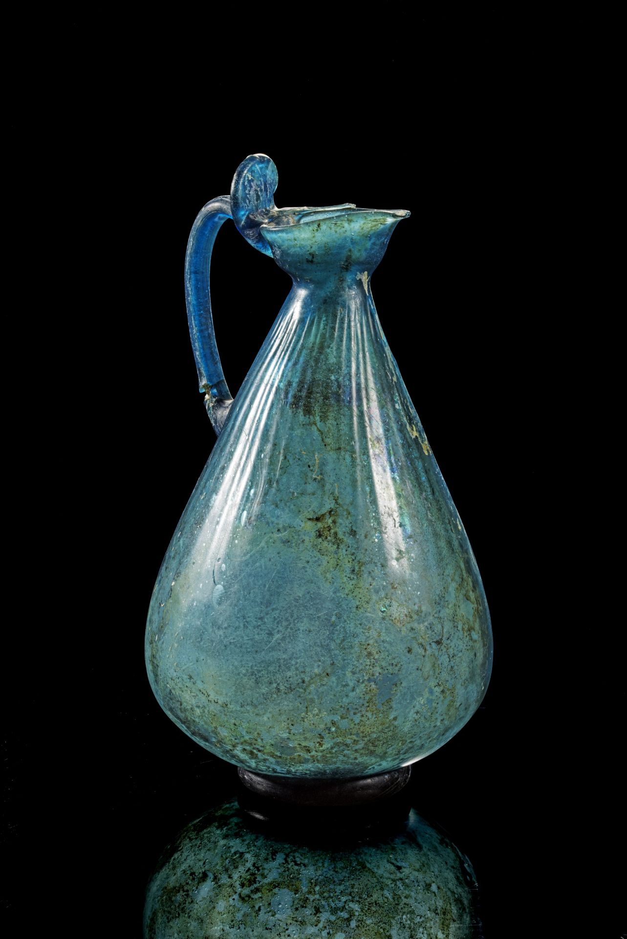 Beautiful early Islamic jug of blue glass.