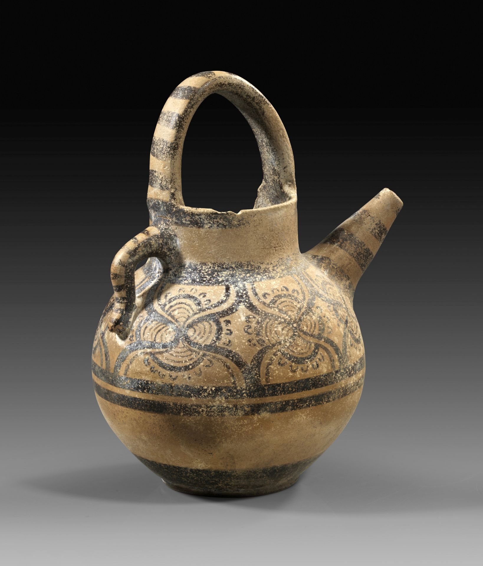 Minoan globular jug with stirrup handle and pointed nozzle. 