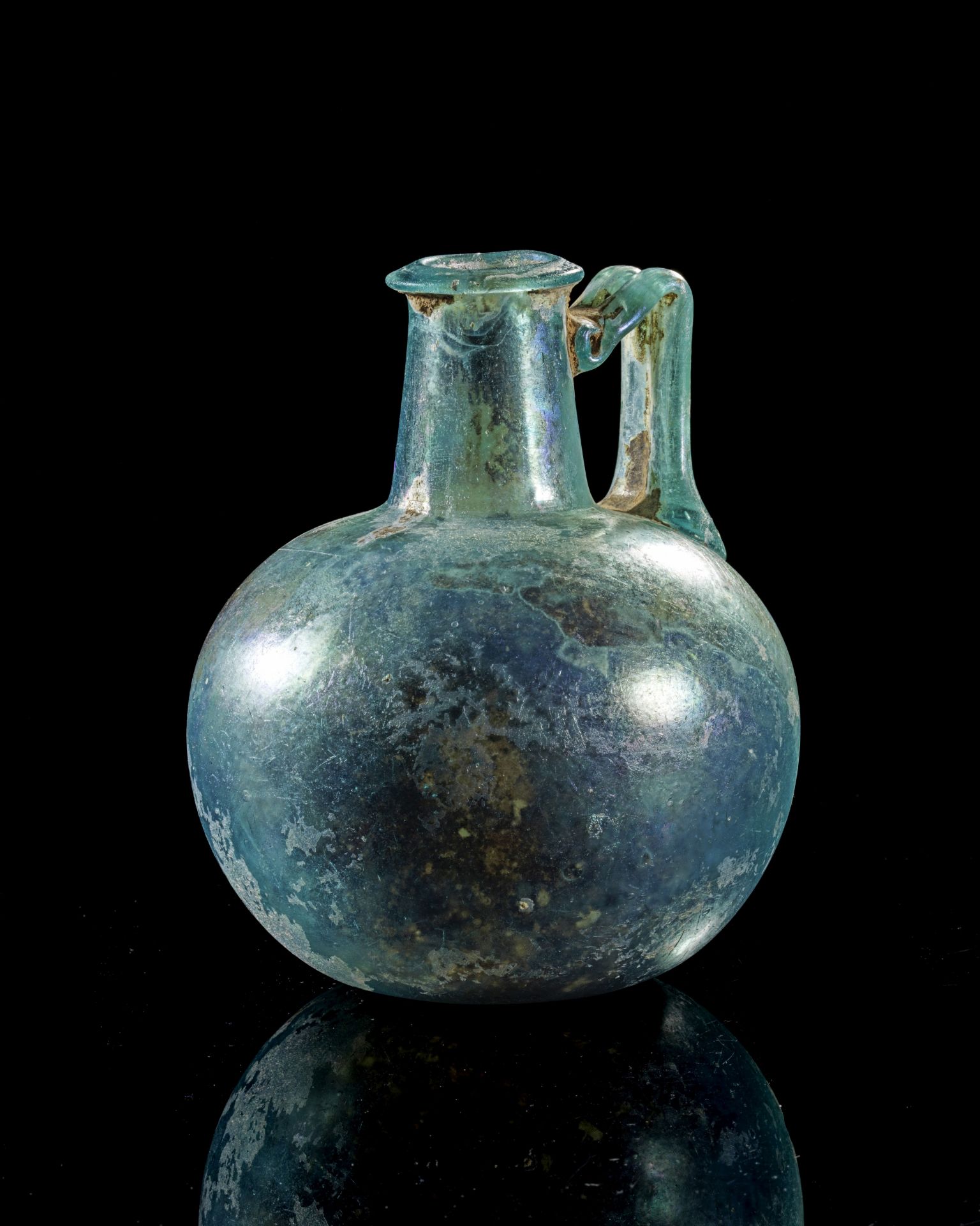Heavy bulbous jug of light blue glass.