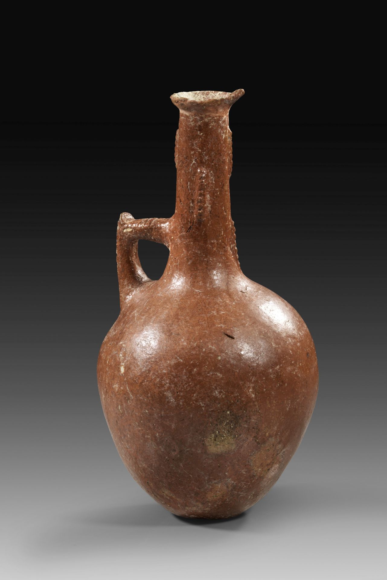 Tall Bottle of the Relief Decorated Mottled Red Polished Ware.