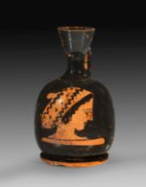 Attic red-figure squat lekythos with head of a woman.