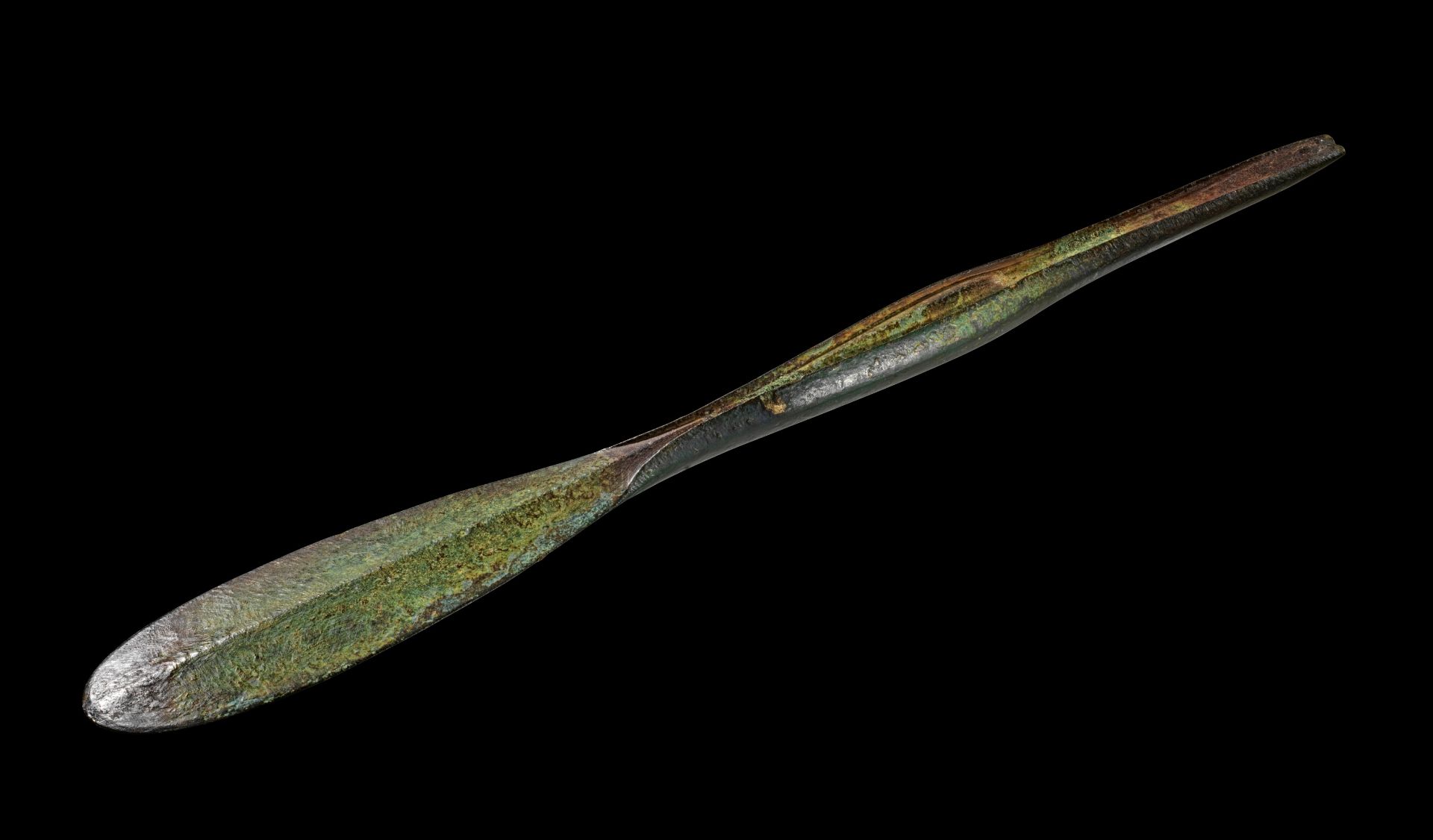 An ancient oxidized bronze tool of spoon-form.