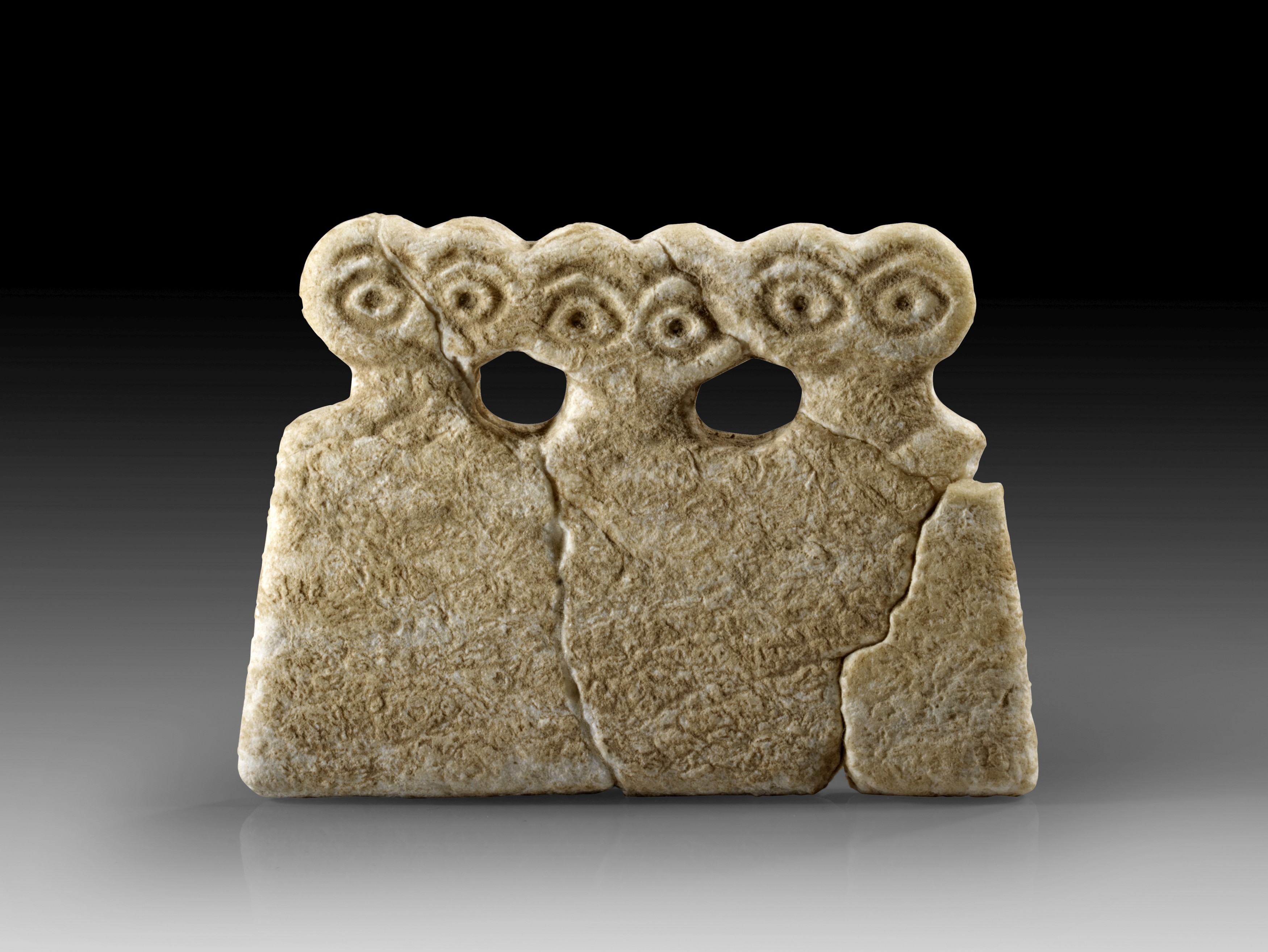 Limestone triple eye idol of the Tell Brak type. 