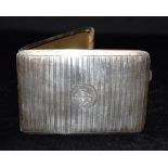 A GEORGE V SILVER CIGARETTE CASE Of machine turned pattern and a central engraved initial,