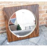 A 1970s FAUX WOOD FRAMED CIRCULAR WALL MIRROR/LAMP 50cm sqaure overall, paper label to back for '