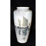 A LARGE BING & GRONDAHL BALUSTER SHAPED VASE decorated with sailing boats, beneath a cloudy sky,