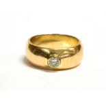 AN UNMARKED YELLOW METAL CLEAR PASTE SET BAND RING size L, bad width 7mm, weight approx. 5.3grams,