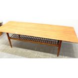 A LARGE TEAK COFFEE TABLE on turned supports with magazine rack undertier, 58cm x 190cm, 46cm high