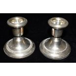 A PAIR OF WEIGHTED SILVER DWARF CANDLESTICKS hallmarked for Birmingham 1978, maker B & Co